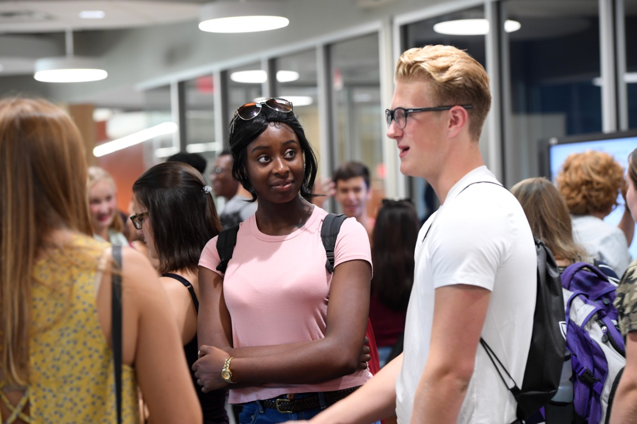 Students and faculty have a conversation while attending the Dalhousie Science welcome party