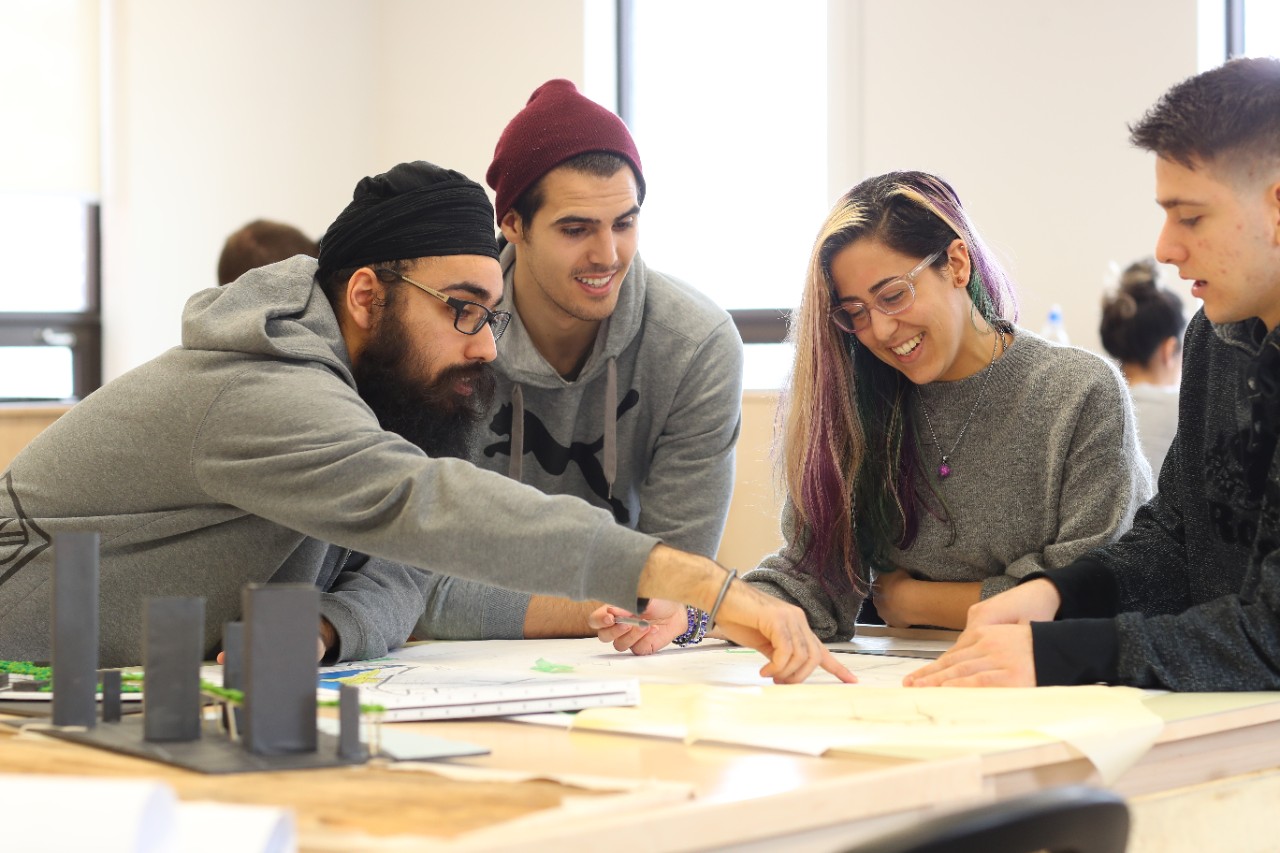 four students meet around a table