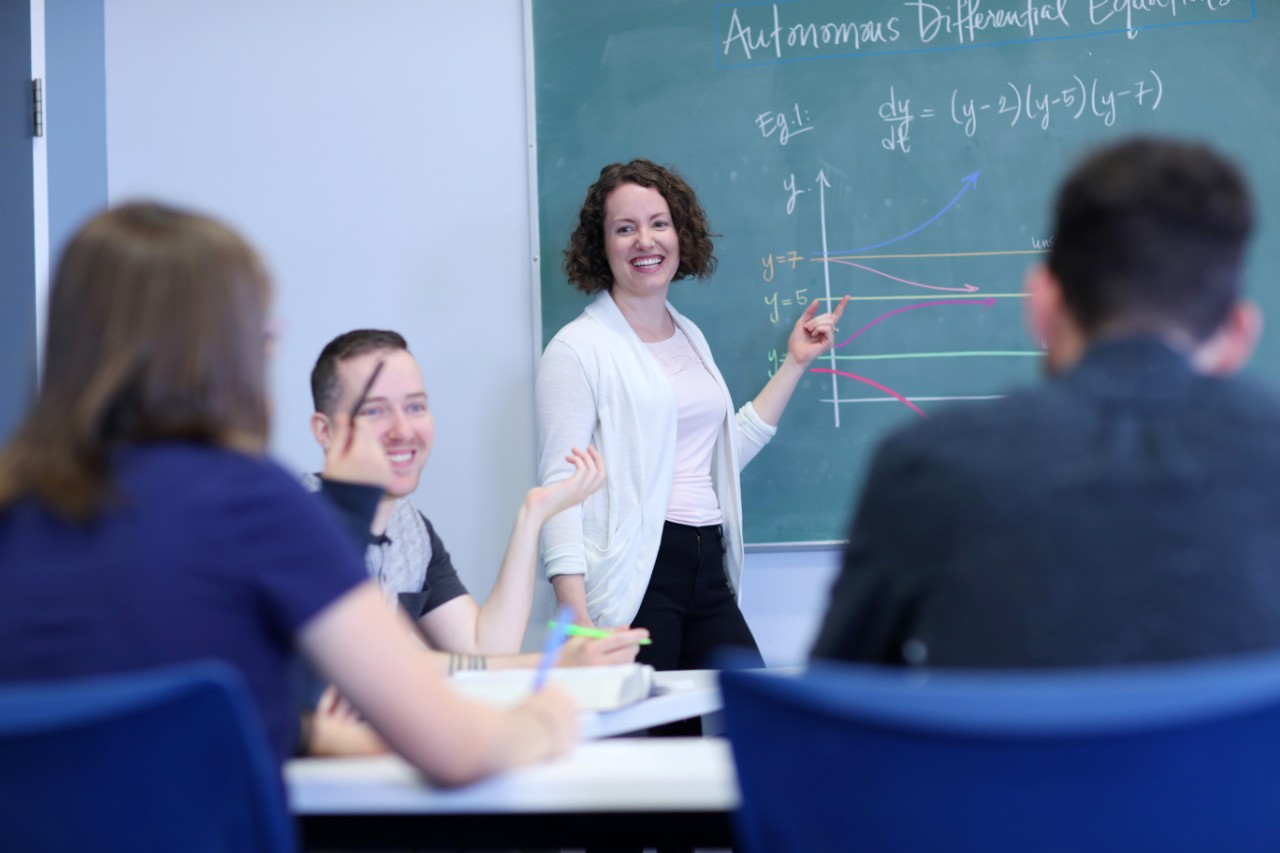 Dalhousie Science students and faculty work on a math problem on the chalk board in a math class