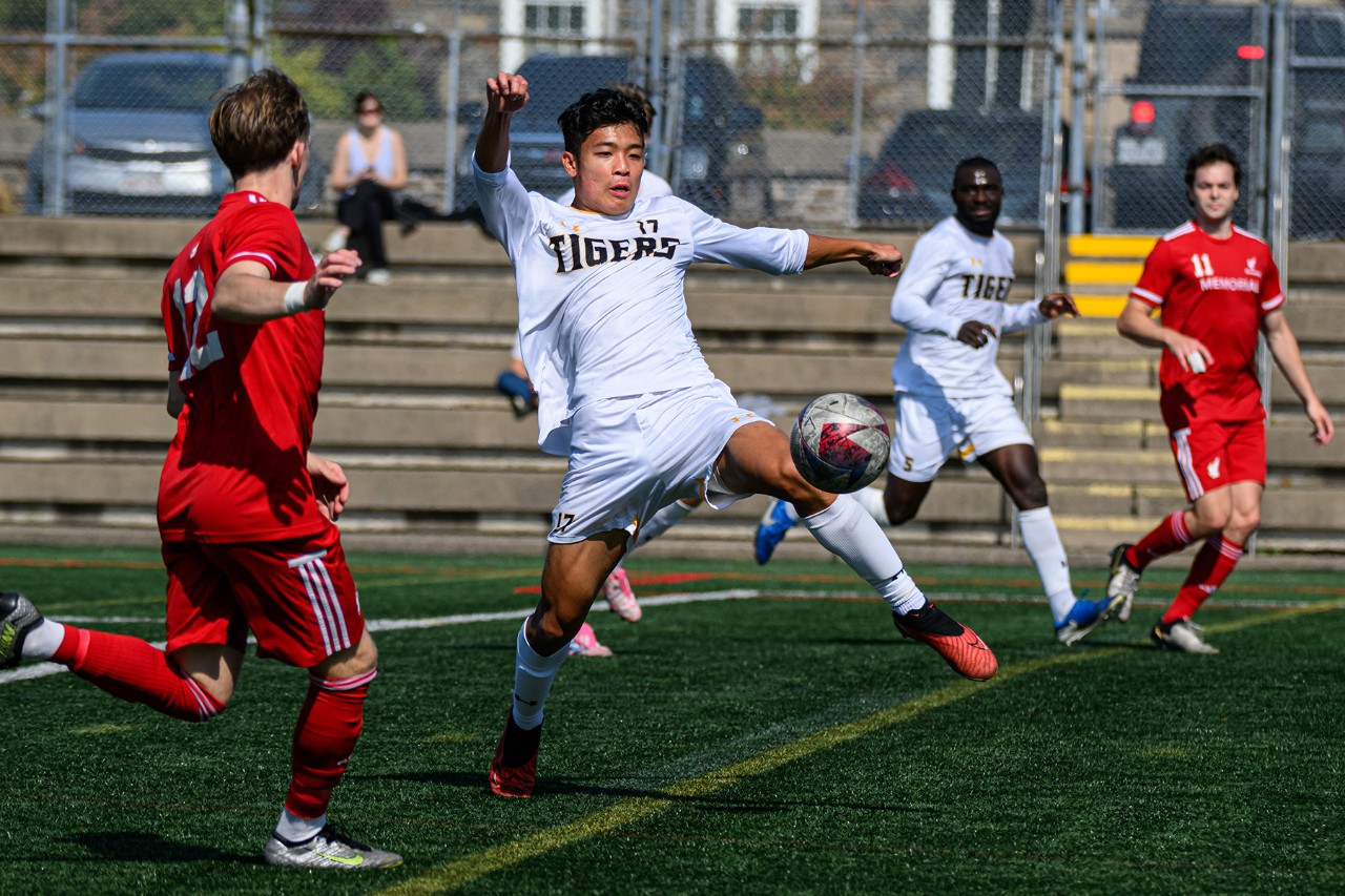 Andrew Chen plays on the Dalhousie Tiger men’s soccer team. Chen and others playing soccer.