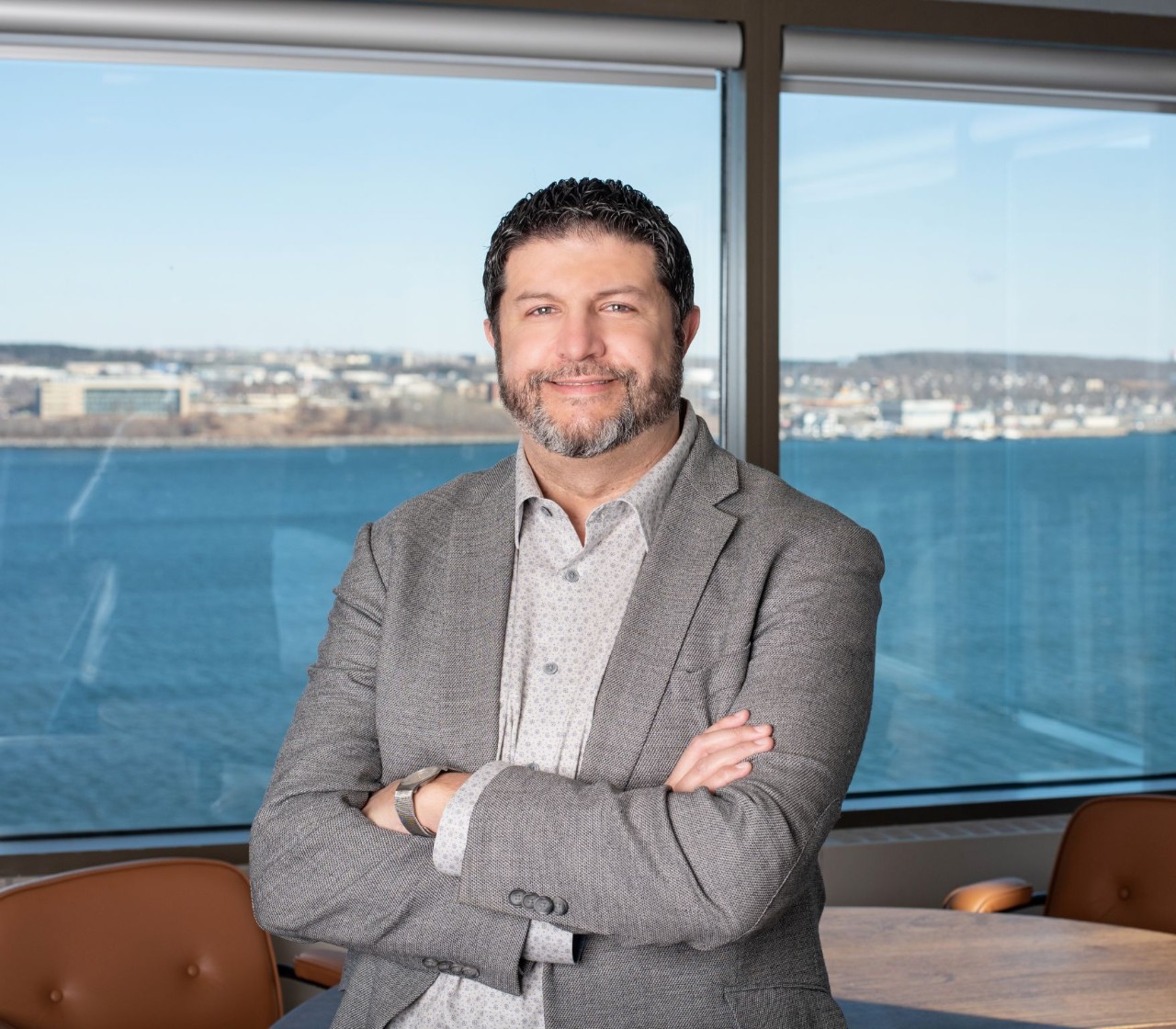 Tobin stands in his office building with an ocean view.