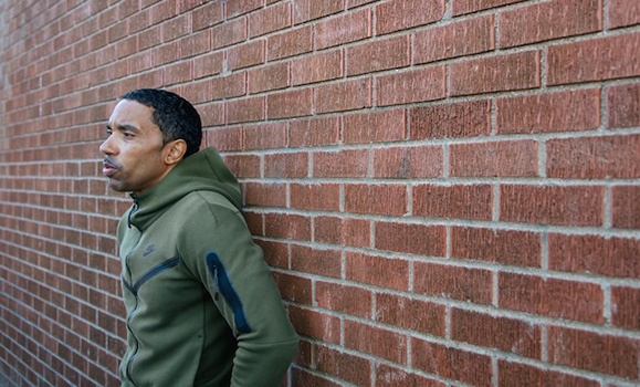 photo of Rodney small leaning against a brick wall