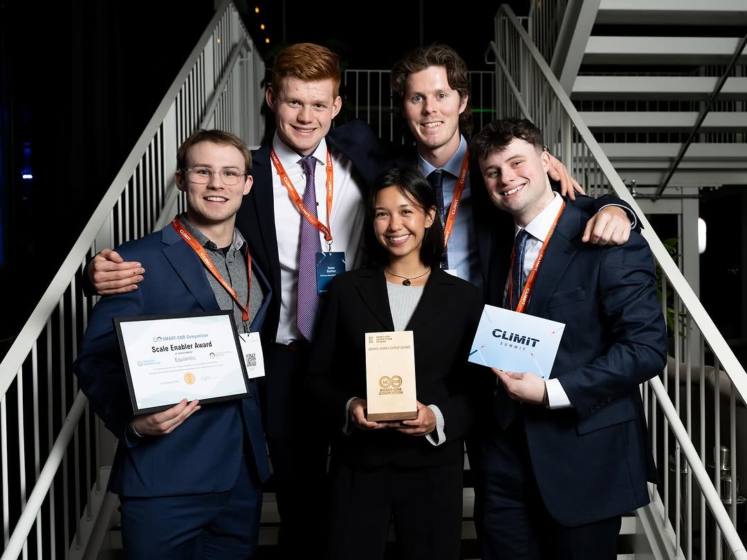 The Equlantic team of 4 men and 1 women standing on a staircase holding their award certificates at the event.