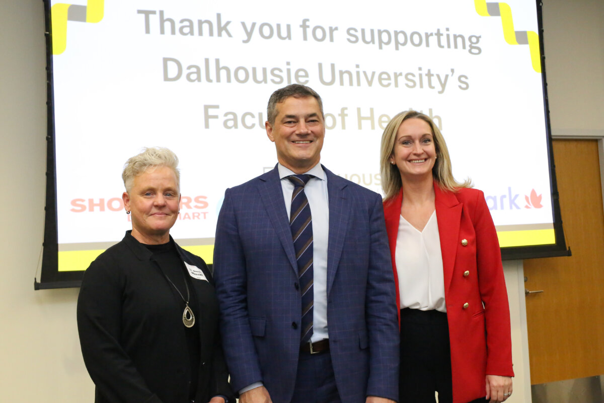 Donors standing in front of thank you sign