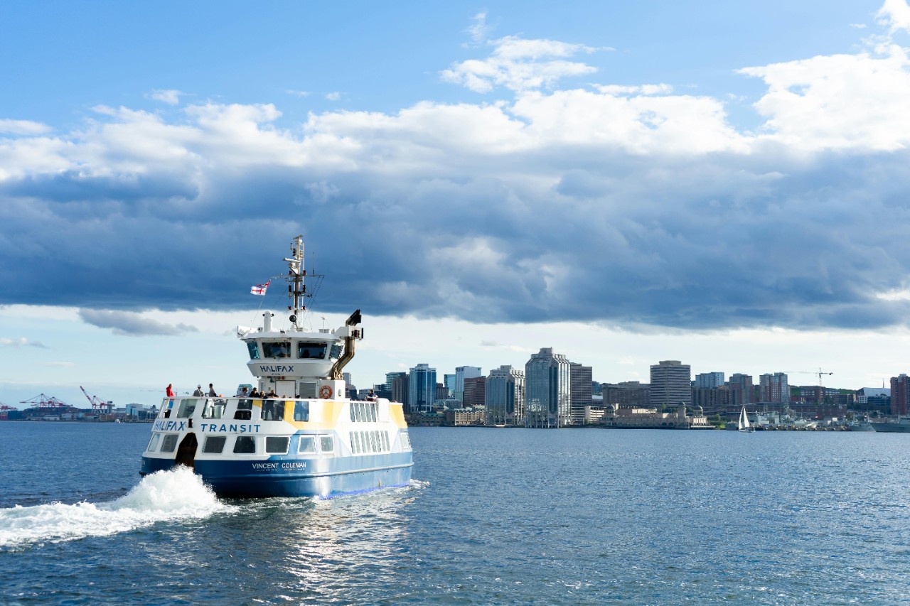 A Halifax Transit ferry sails to Halifax on a sunny, calm day. 