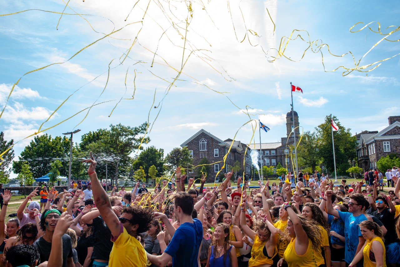 A joyful crowd of students celebrating O-Week on the quad