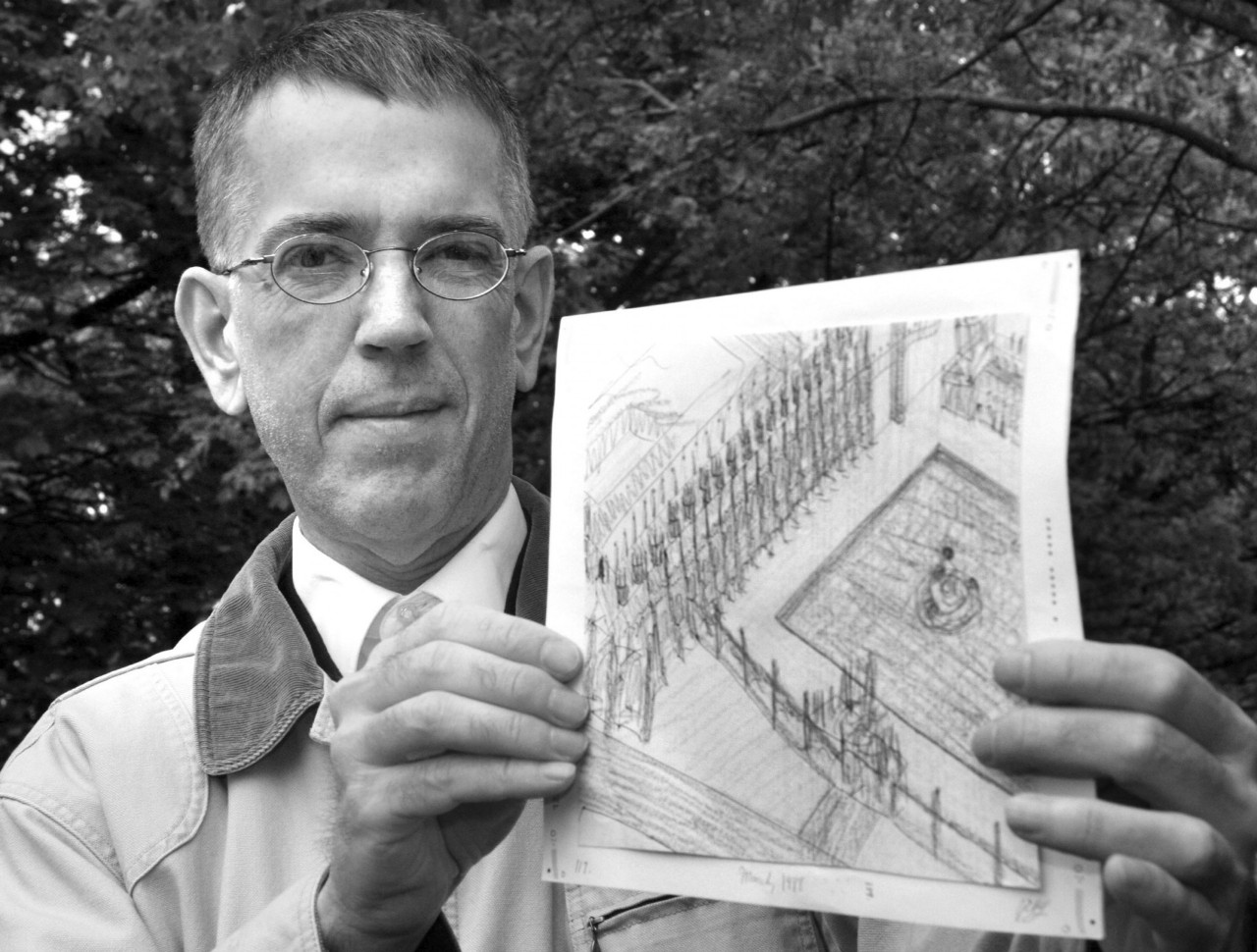 John Devlin holding up a piece of his artwork.