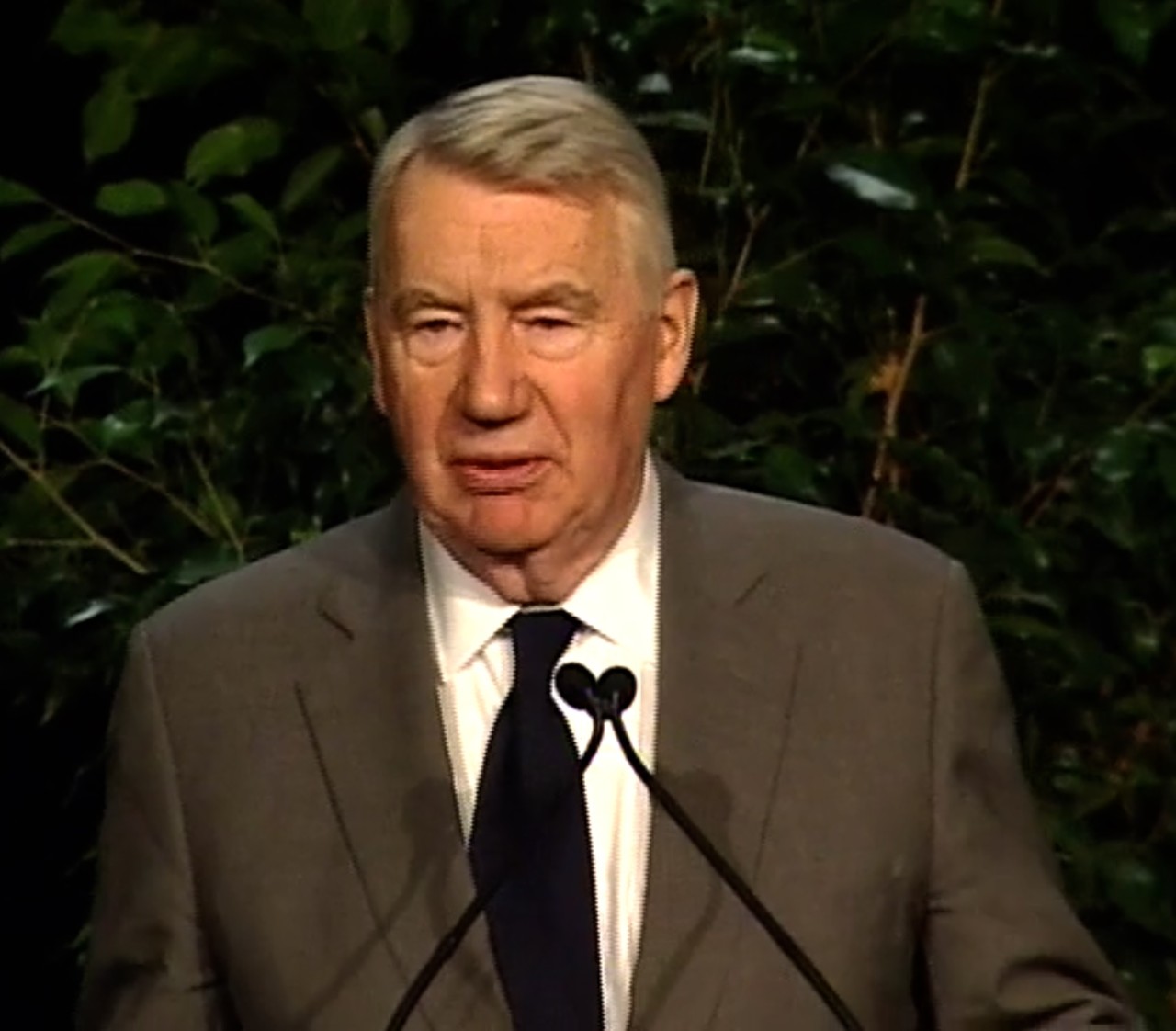 Robert (Robin) MacNeil speaking at an event.