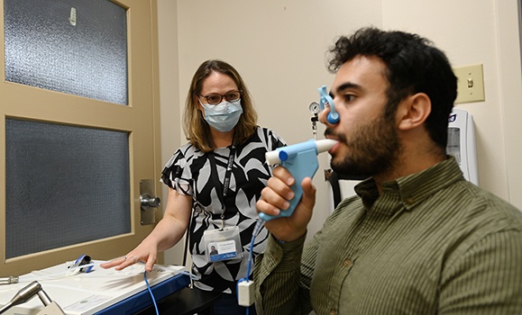 person using a spirometer under medical supervision