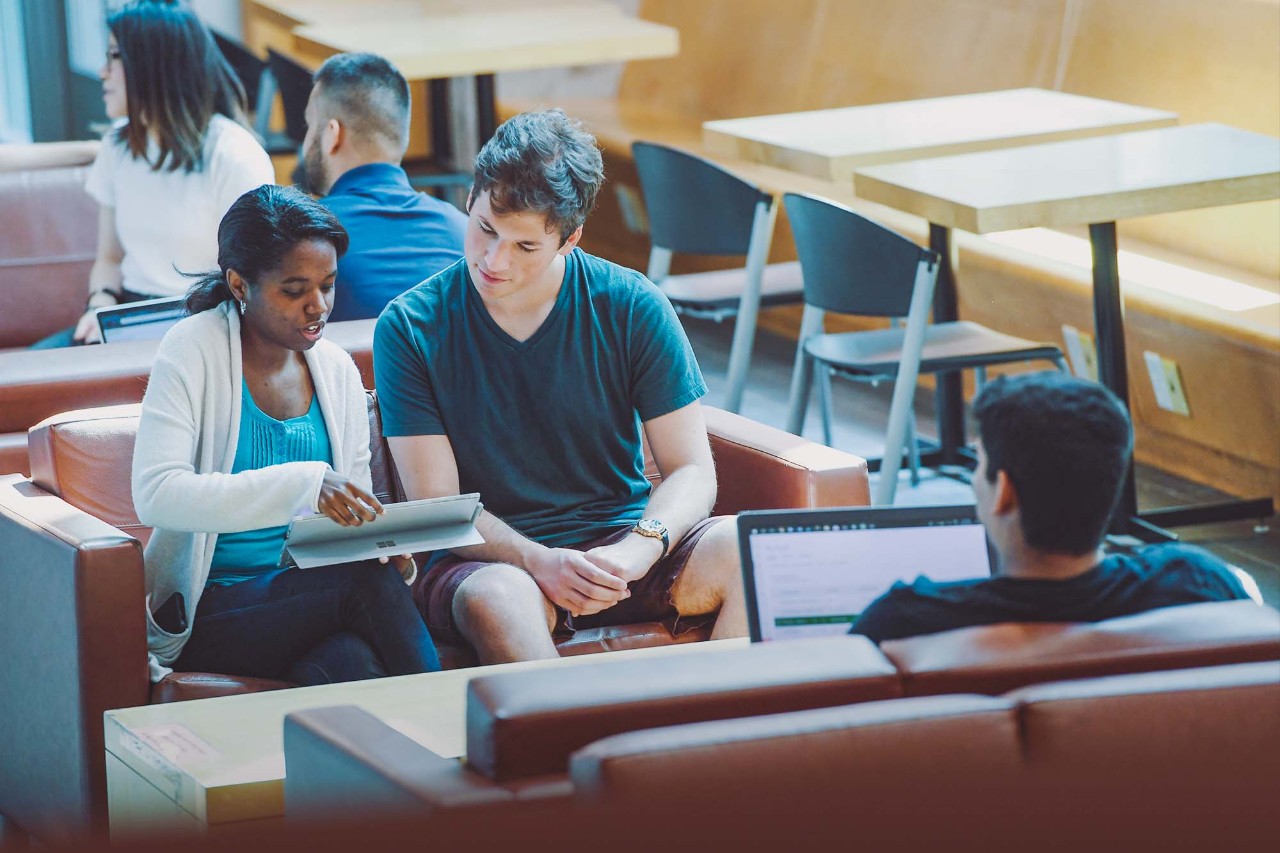 Students collaborating on the couches in the Goldberg Computer Science Building.