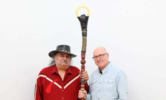 Artists Syliboy and Austin with the New Dawn Staff