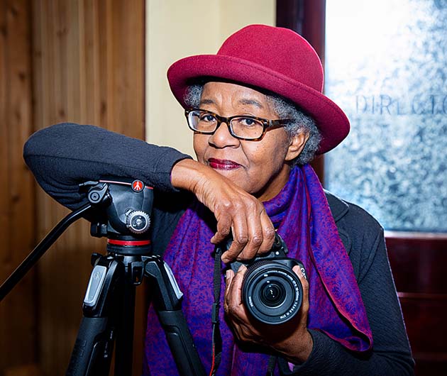 Sylvia Hamilton portrait holding a camera.