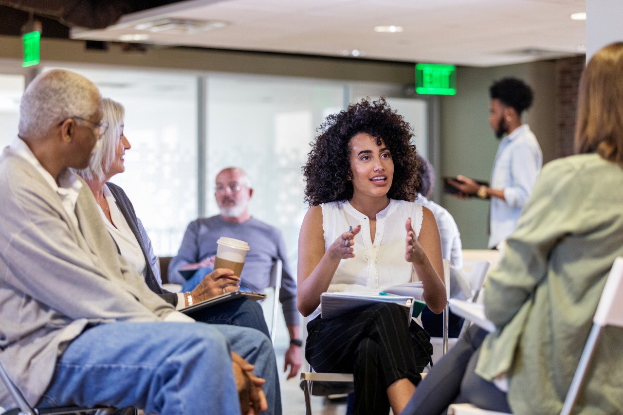 A woman uses gestures to emphasize her point during a meeting