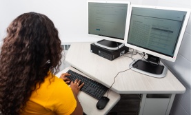 Student taking an exam on a computer Student taking an exam on a computer