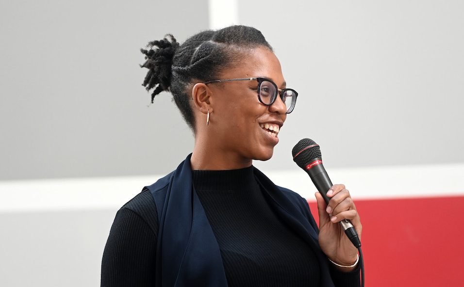 Woman speaks into a microphone.
