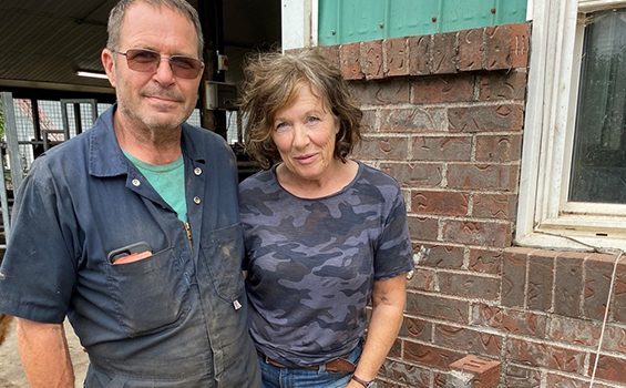 Agriculture alumni and dairy farmers John and Angela Van de Riet standing together at Sunni Knoll Farms.