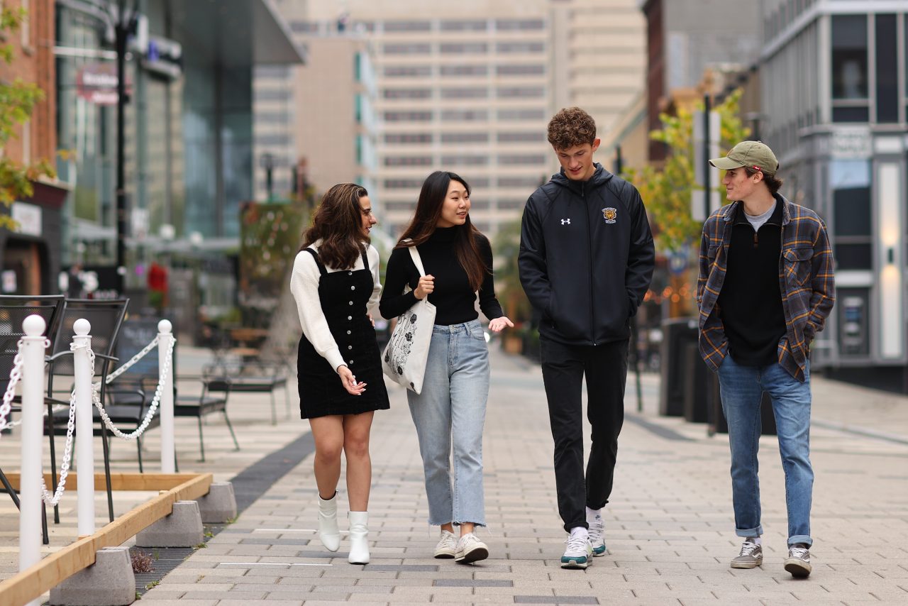 four students walk down Argyle Street