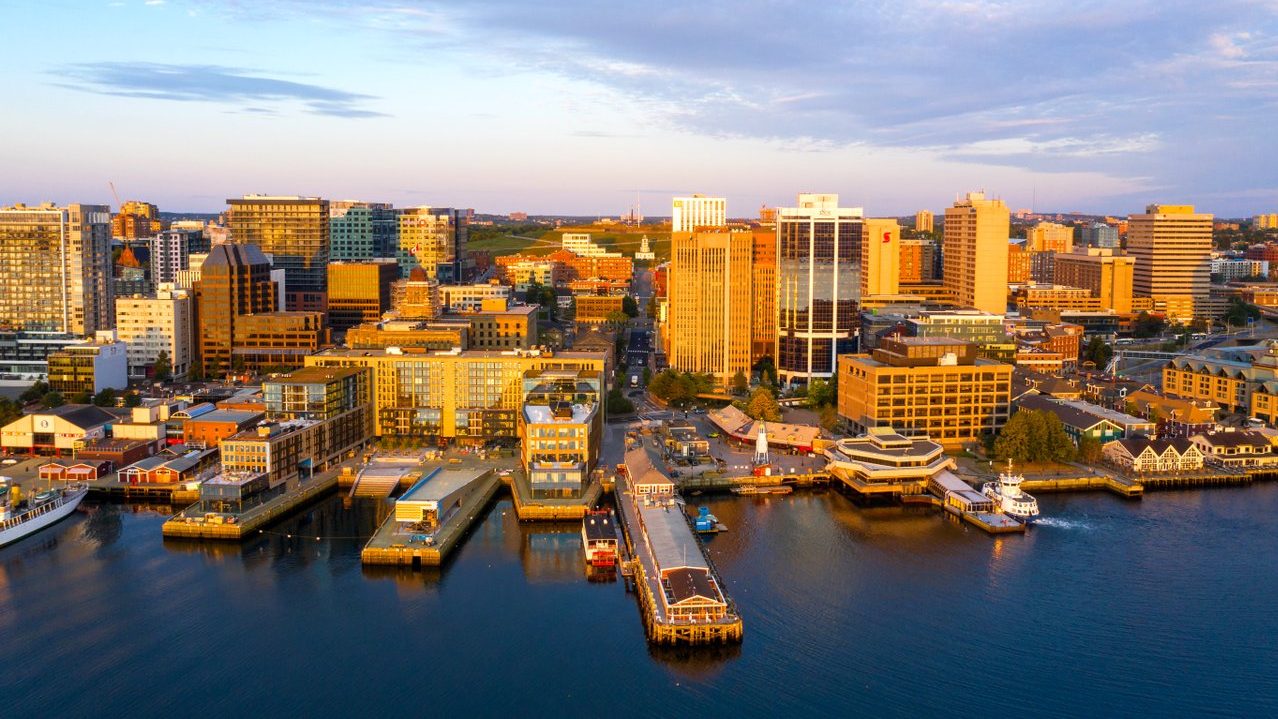 Halifax waterfront with city skyline at dusk.