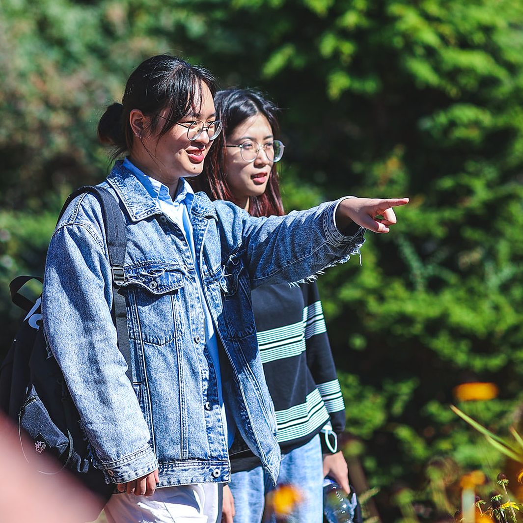 Two students walking on campus.