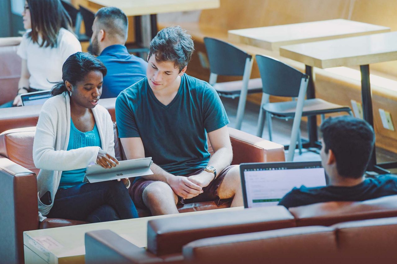 Students collaborating on the couches in the Goldberg Computer Science Building at Dalhousie University.