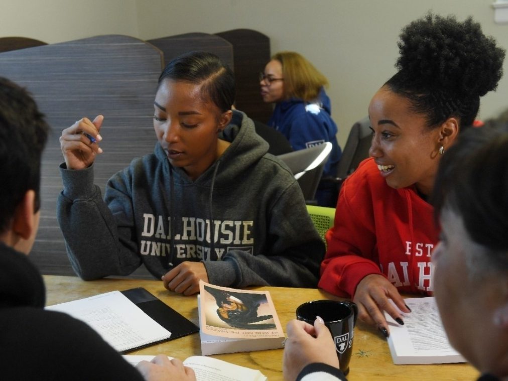 Transition Year Program students. Group of students sitting around a table with open books.