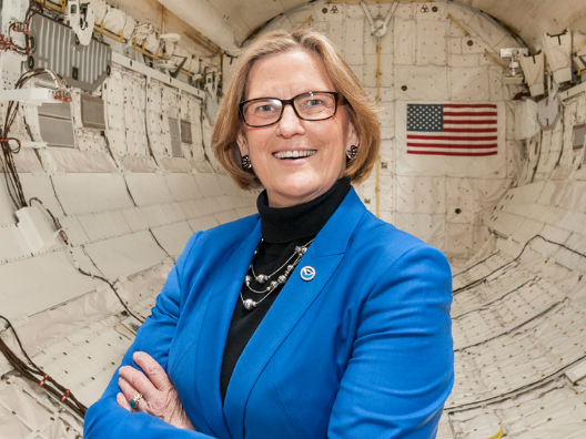 Dr. Kathryn Sullivan stands insight the Space Shuttle Discovery.