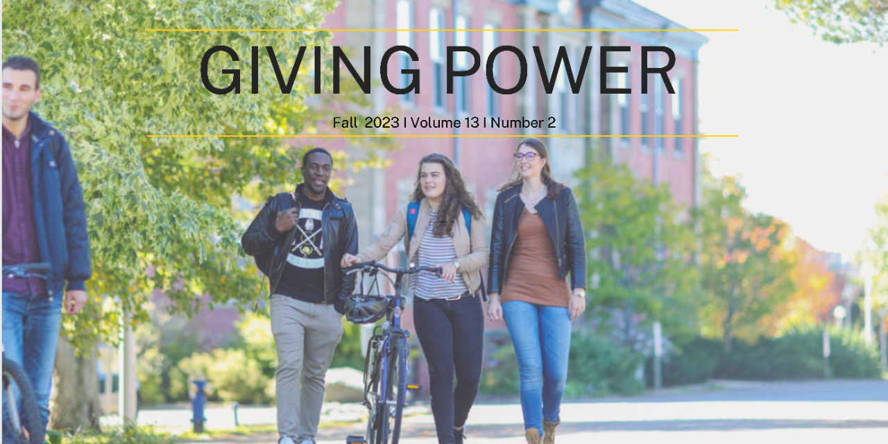 Three students walking across campus with the words Giving Power over the image