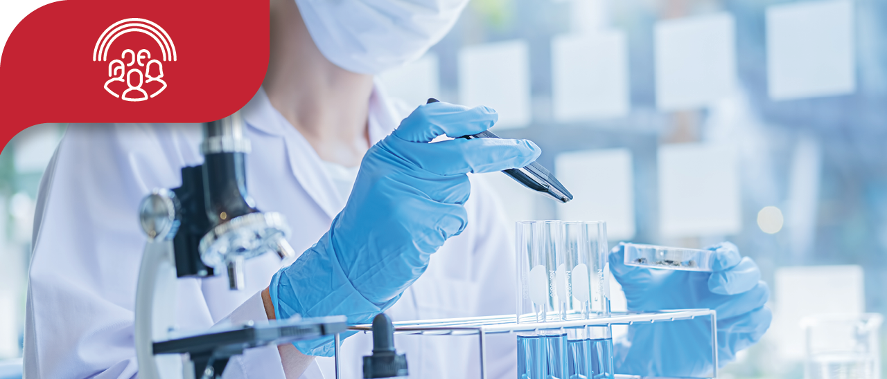 scientist wearing gloves and a mask working with test tubes in a laboratory