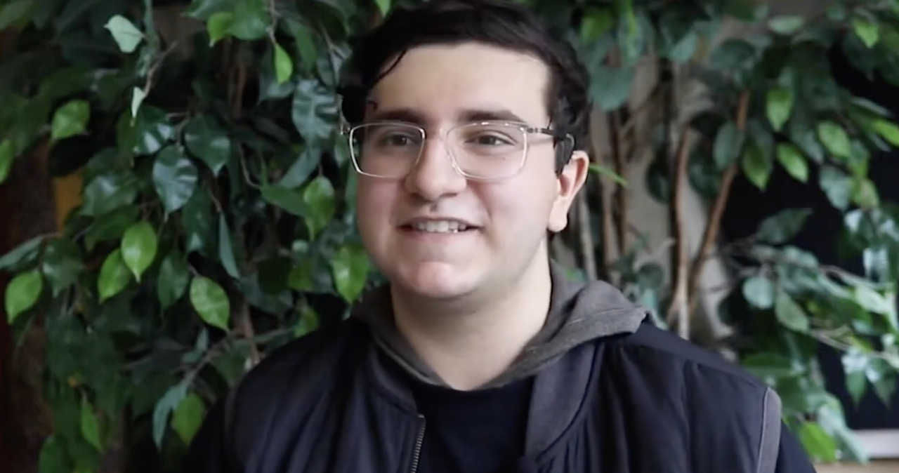 Male presenting student wearing glasses.